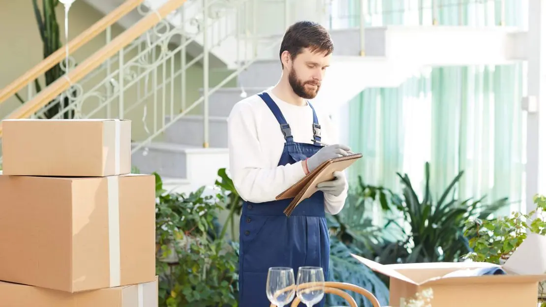 Moving company foreman writing information about delivery Affordable Apartment Moving