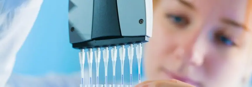 female scientist looking closely at stem cell therapy research
