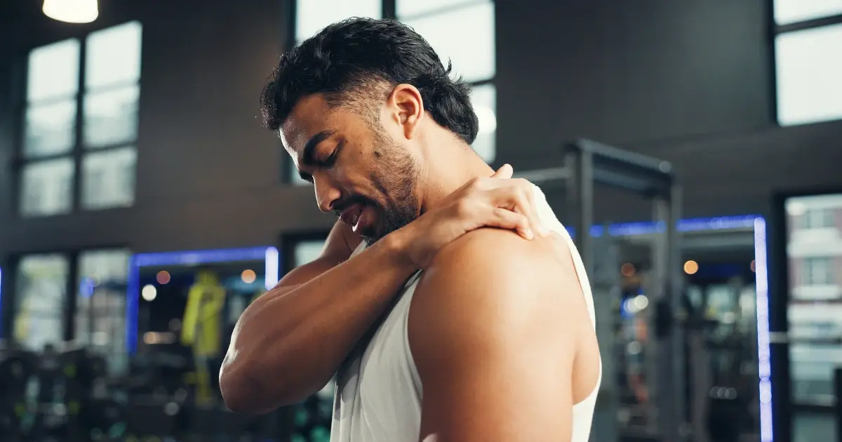 Man holding shoulder showing discomfort from chronic joint condition