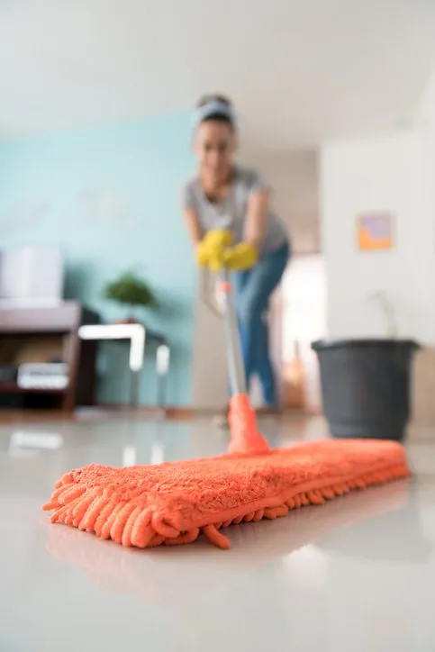 Woman mopping living room floors