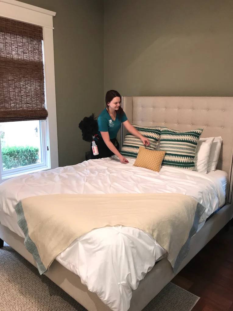Britlin cleaner making bed in Round Rock home