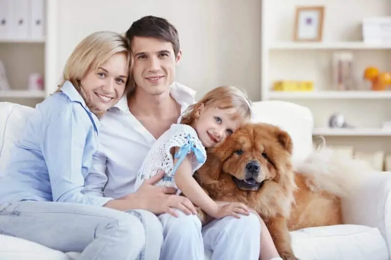 Family on couch with dog