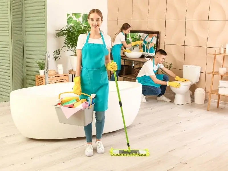 7 Tips for Efficient Bathroom Cleaning Three house cleaners in modern bathroom