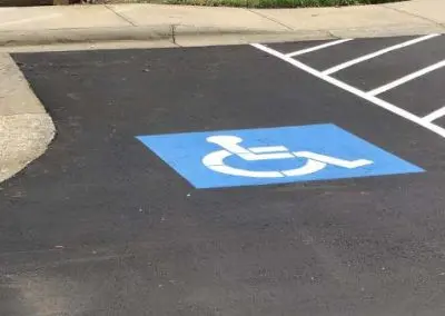 ADA handicap parking stencil with fresh blue and white striping