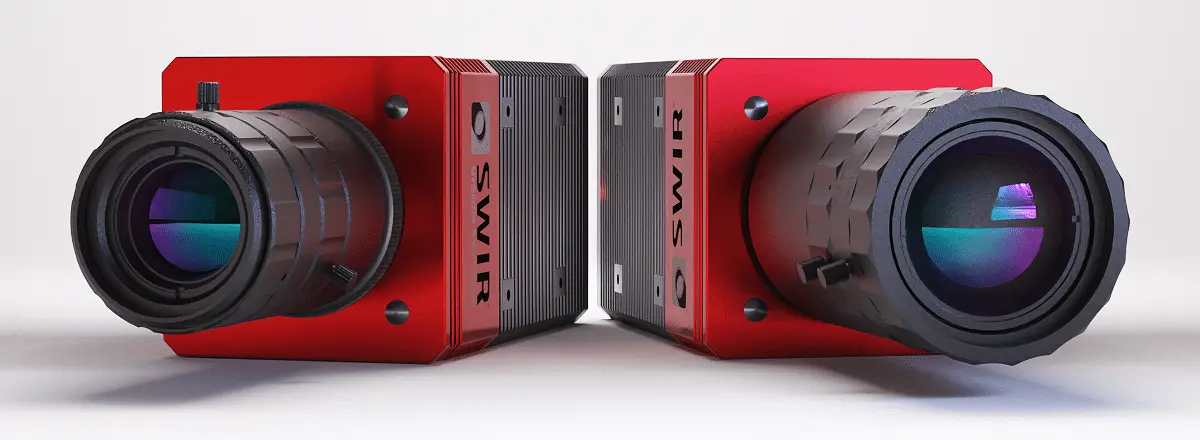 Two SWIR Vision Systems Acuros CQD SWIR cameras with extended lenses, shown side by side against a white background