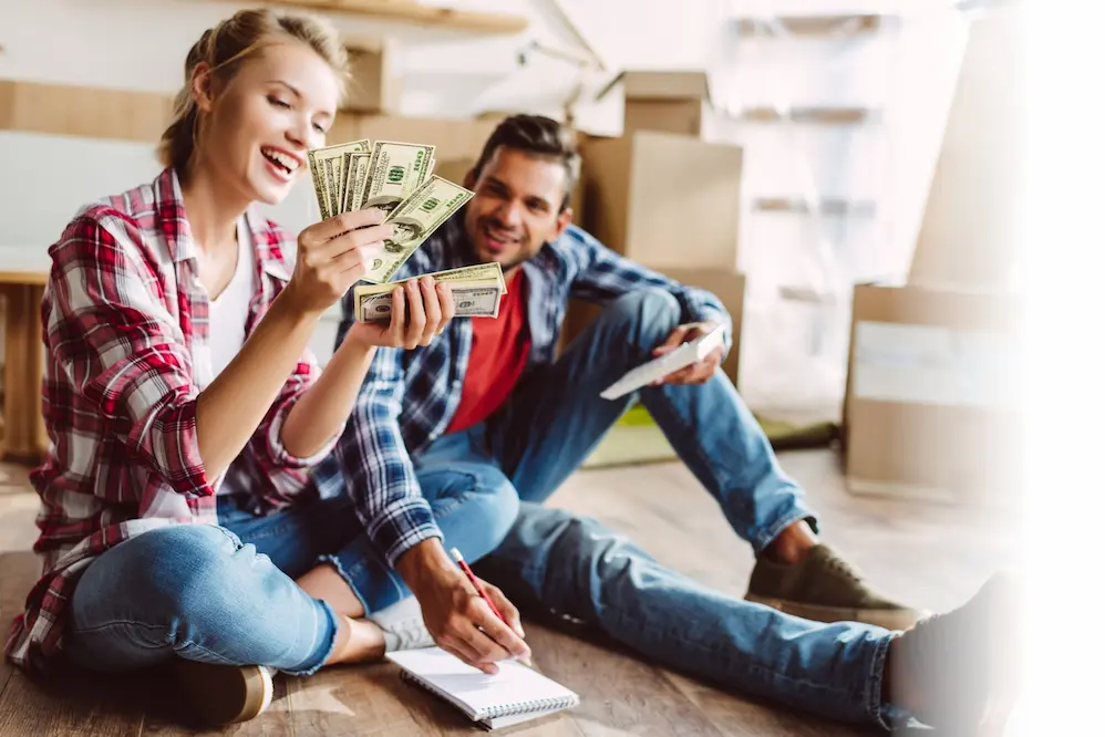couple counting bills, budgeting, after payday