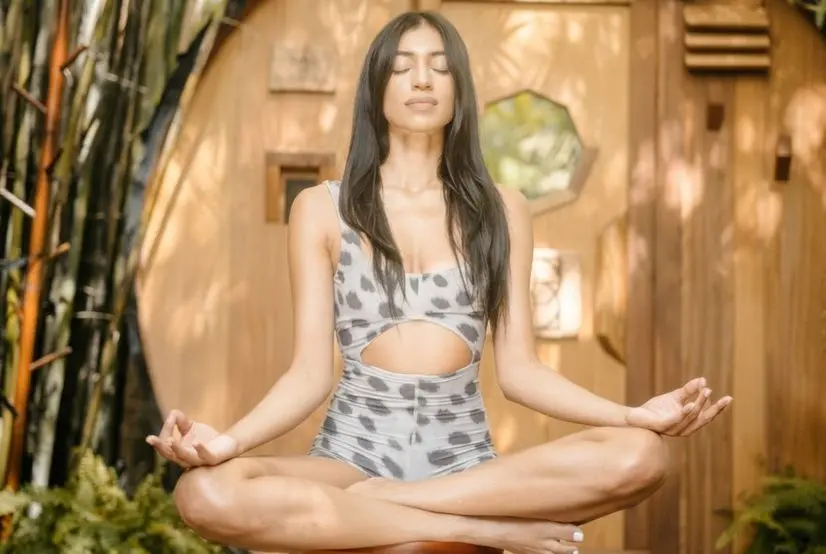 Woman practicing a mindful breathing technique for stress and anxiety in a calm seated meditation at SILA Miami in Miami, FL