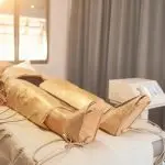 Person lying in a lymphatic drainage suit during a detox session at Sila Miami, FL.