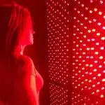 Client experiencing red light therapy benefits at SILA Miami with red and near-infrared light supporting cellular renewal and skin health