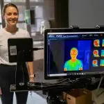 A woman receiving a wellness screening with the BioScan 360 device at SILA Miami in Upper Buena Vista, featuring advanced health metrics and body scan technology.