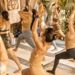 Group yoga at SILA Miami builds flexibility, balance, strength, and mindfulness in a tropical social wellness community.