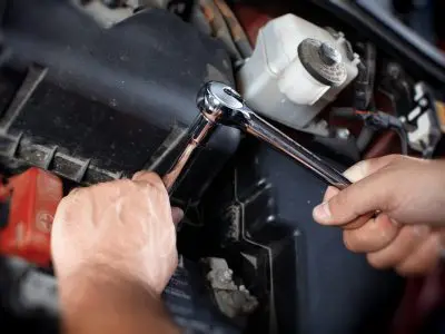 Mechanic working in auto repair garage. Car maintenance