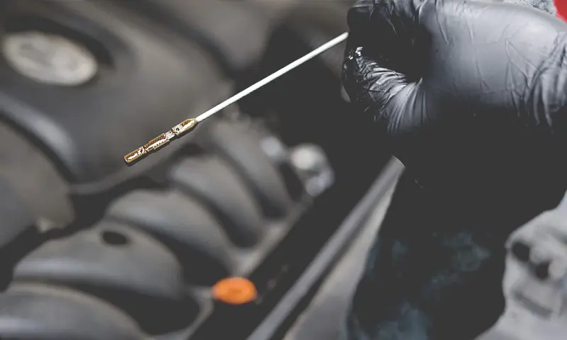 Automotive Oil Check Close Up of Gloved Hands and Oil Stick at Spirit One Automotive Repair Shop in West Benton Park St. Louis Missouri