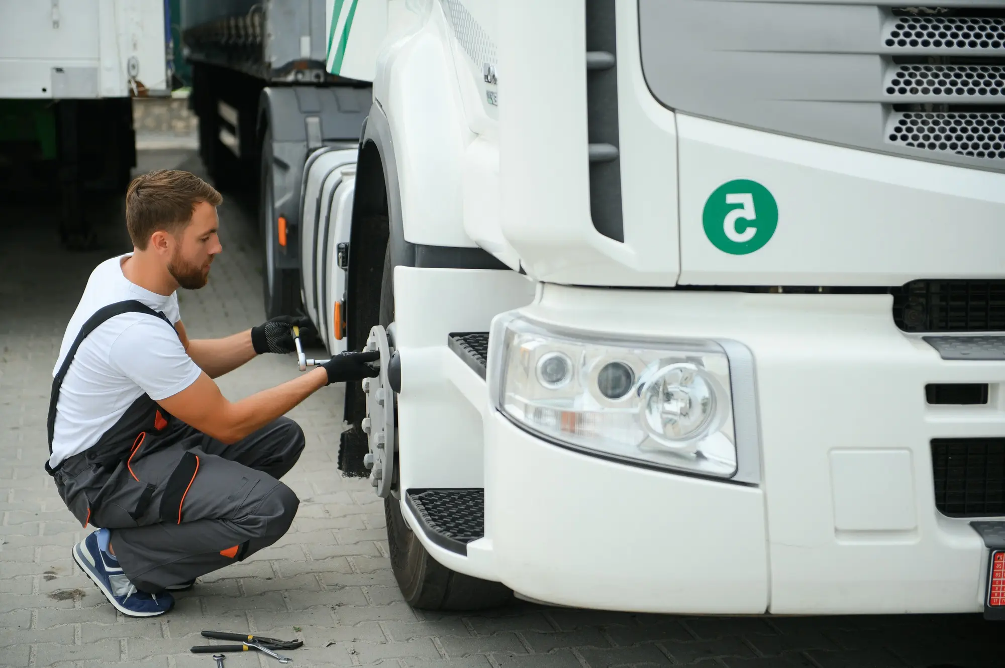 Caucasian Professional Truck Mechanic Rebuilding Heavy Duty Truck Diesel Engine