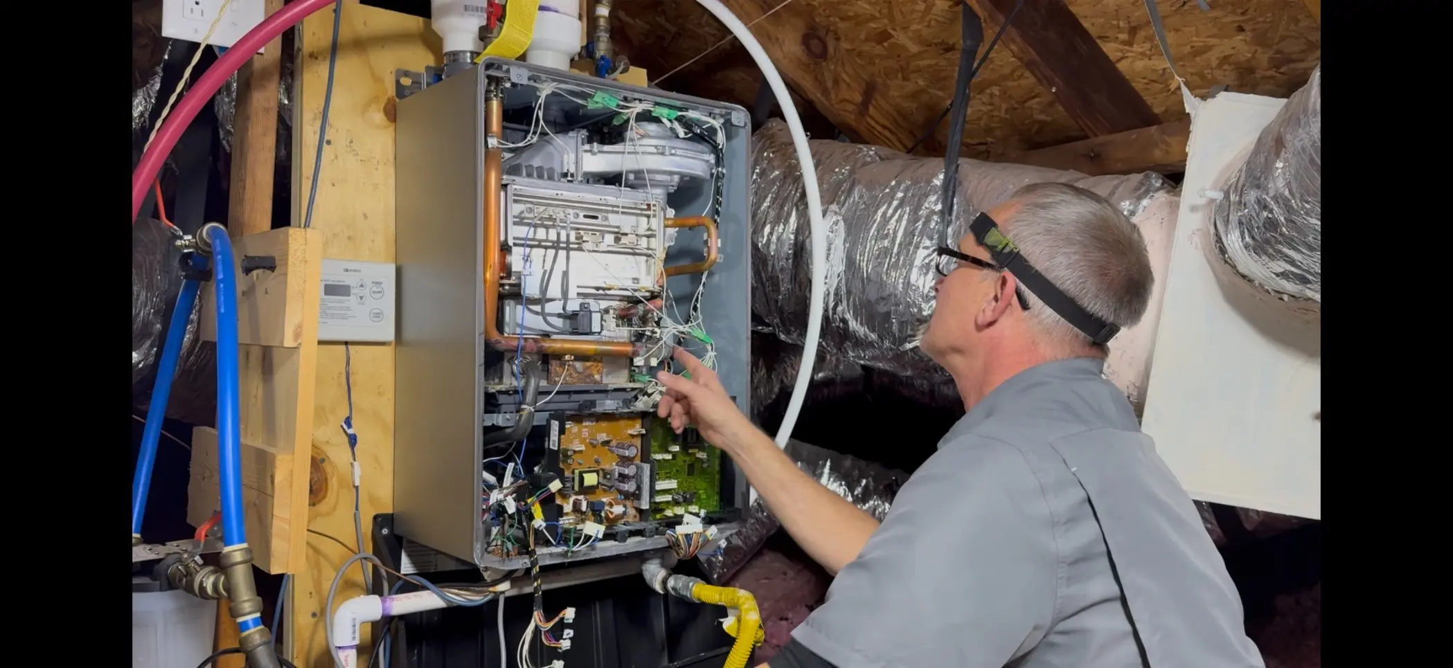 On The Way HVAC technician performing heating system diagnostic in attic