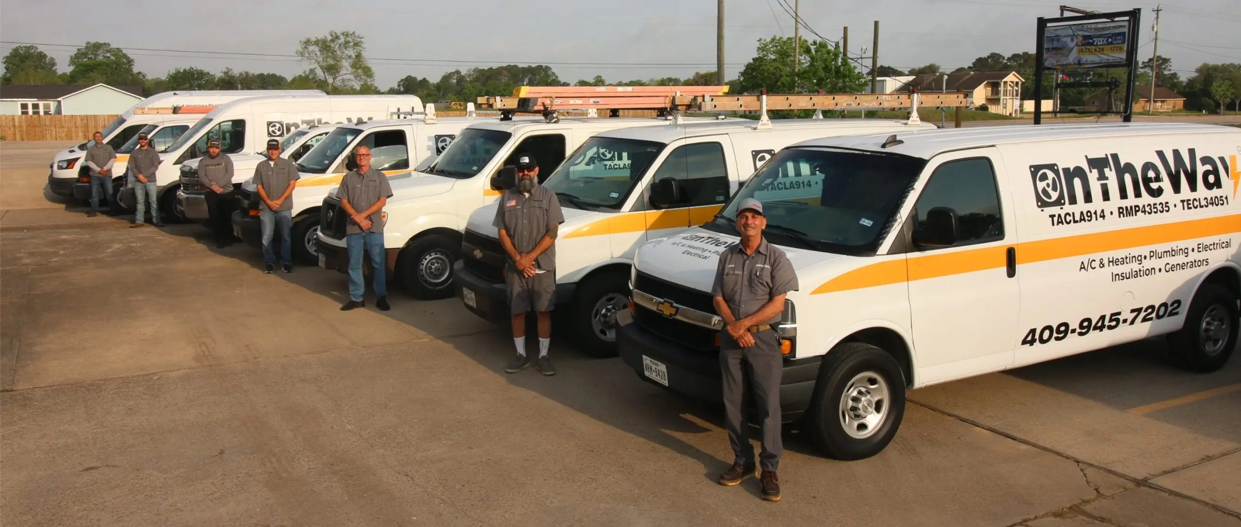 On The Way team of technicians standing in front of their fleet of service vans in Santa Fe TX