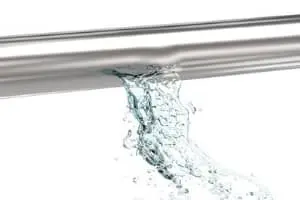 Leaking pipe with water flowing out, highlighting plumbing issues relevant to bathroom plumbing services and water conservation tips by B&L Plumbing and Heating.