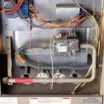 Gas control system with wires, valves, and safety labels for heater maintenance by B&L Plumbing in Colorado Springs.