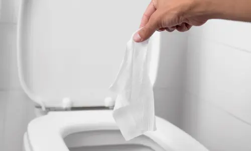 throwing toilet paper down the toilet 