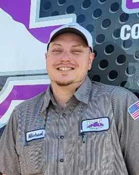 Smiling technician Michael Alfrod in work uniform with B&L Plumbing and Heating logo, showcasing expertise in plumbing and HVAC services.