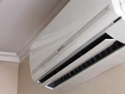 Ductless mini-split air conditioning unit mounted on a wall, illustrating modern cooling technology relevant to HVAC system discussions.