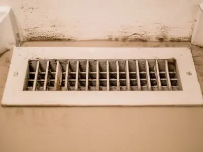 Mold growth on HVAC air vent, illustrating maintenance issues and potential health risks in home heating systems.
