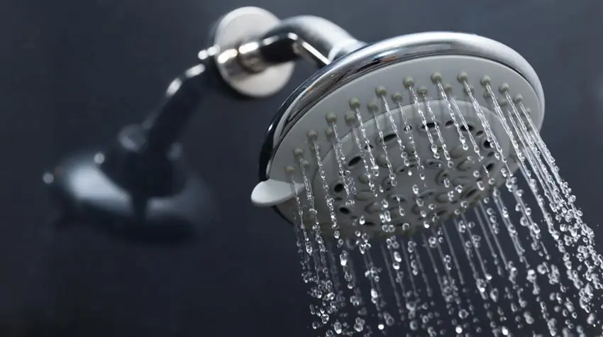 Showerhead with water flowing, representing Bud's Plumbing & Repair Service's shower installation and repair services in Evansville, IN.
