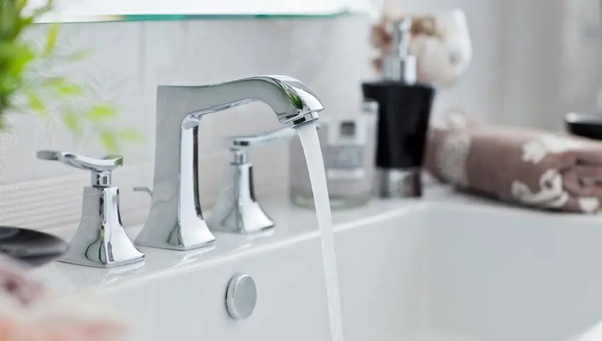 Modern chrome faucet with running water, showcasing sink installation and plumbing fixtures, emphasizing Bud's Plumbing & Repair Service's expertise in faucet and sink services in Evansville.