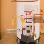 Water heater with copper piping, safety panel, and drain valve for effective plumbing maintenance and water conservation.