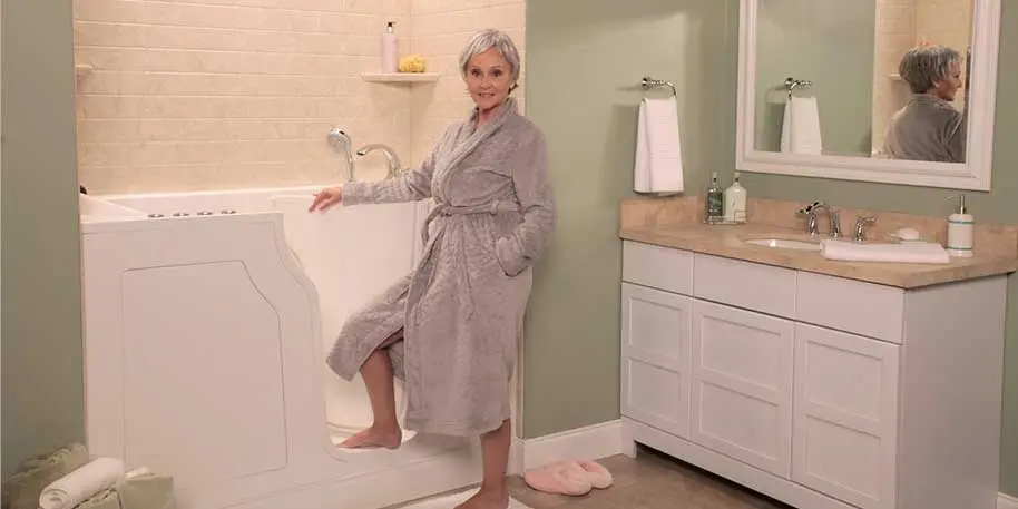 Older woman in accessible bathroom with organized features, showcasing Bud's Plumbing remodeling services in Evansville.