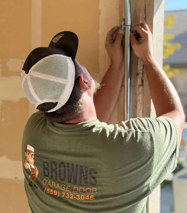 door-track-installation A close-up shot of a technician performing comprehensive tune-up during a garage door repair in coalinga, california
