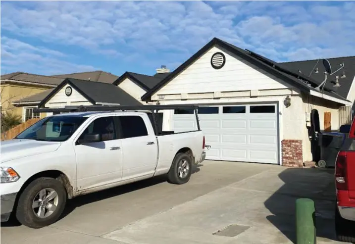 The Browns Garage Door service vehicle parked in a residential driveway, fully equipped to handle any garage door repair in Dinuba, CA