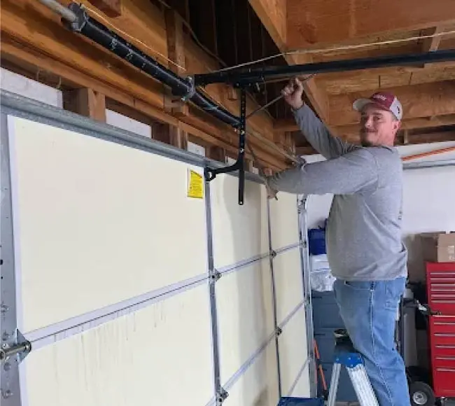 garage-spring Experienced technician safely replacing a worn-out torsion spring on a residential garage door