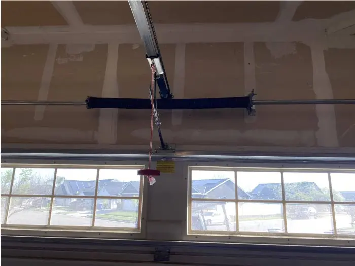 garage-spring-repair Repaired garage door spring mechanism ensuring smooth, quiet, and reliable door movement.