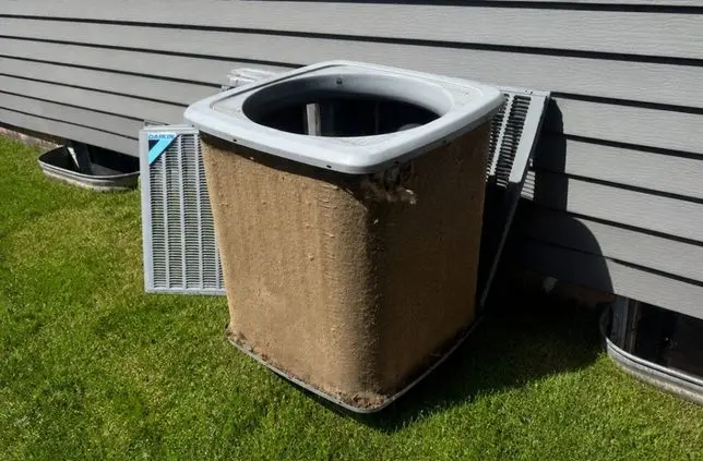 Before: AC condenser coil covered in dirt and debris