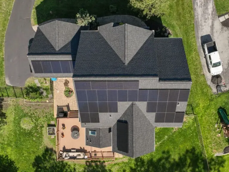 Aerial view of a residential home with solars installed on the roof