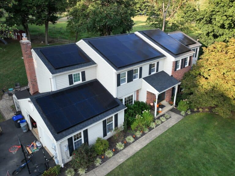 solar panels line the top of asphalt shingles
