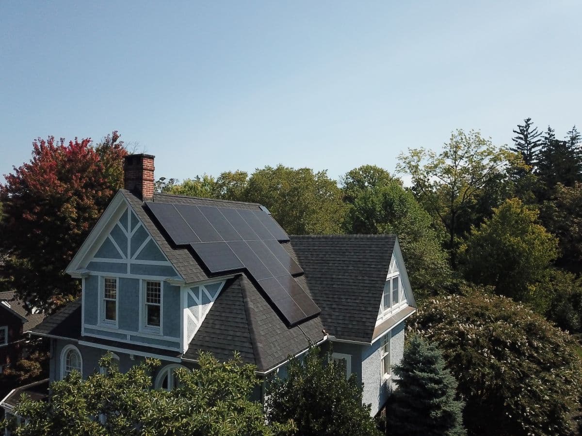 Roof with solar panels surrounded by trees