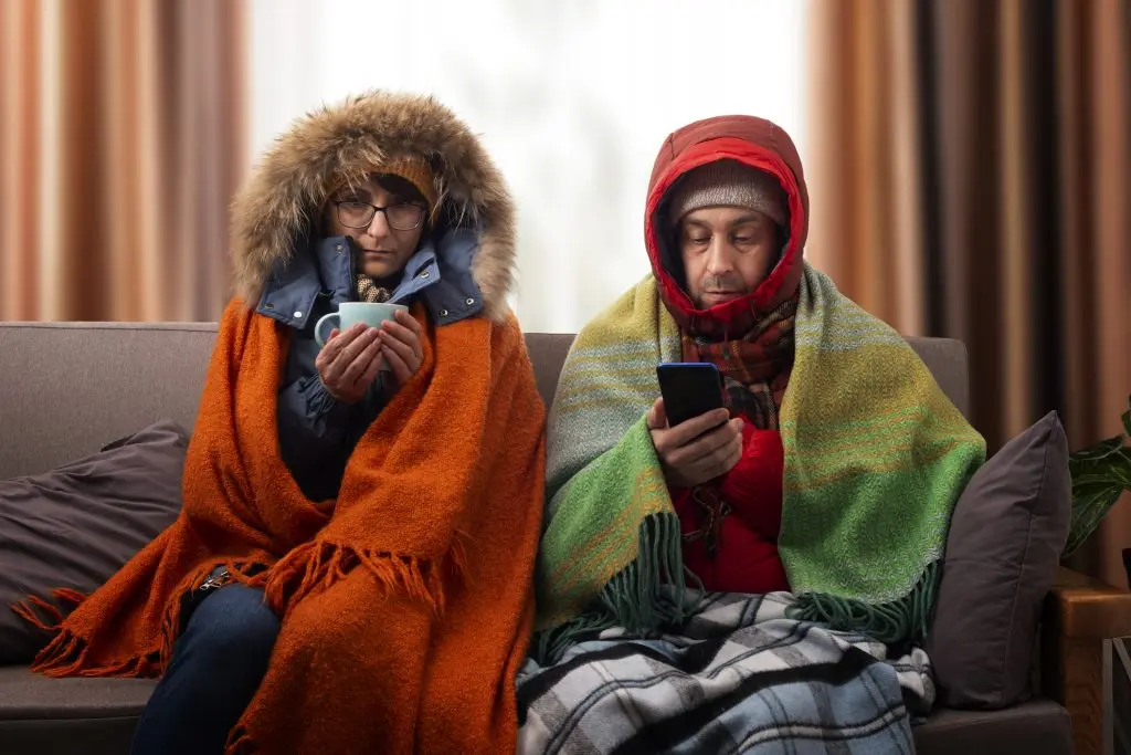 Couple on a couch cold calling about furnace repair