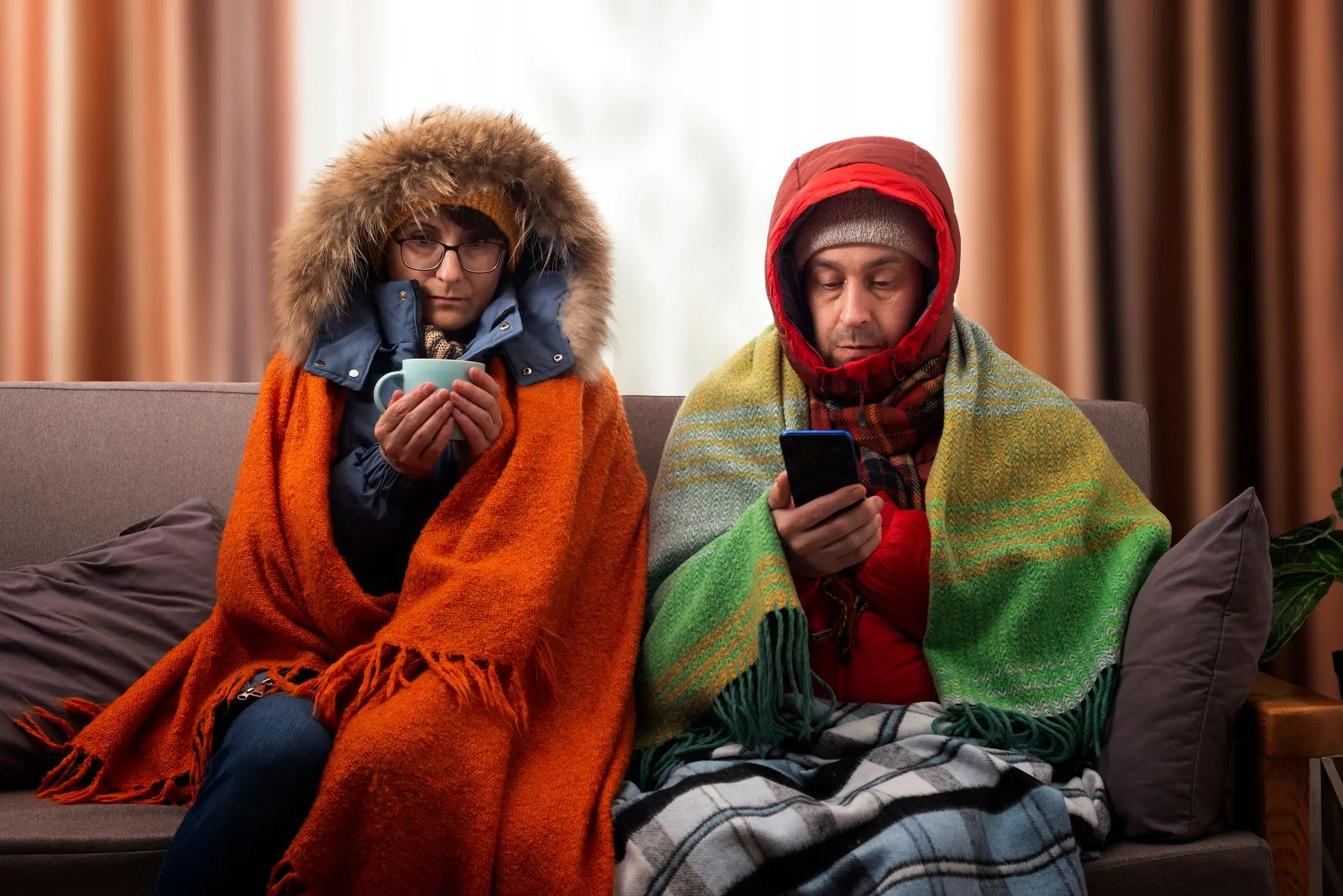 Couple on a couch cold calling about furnace repair