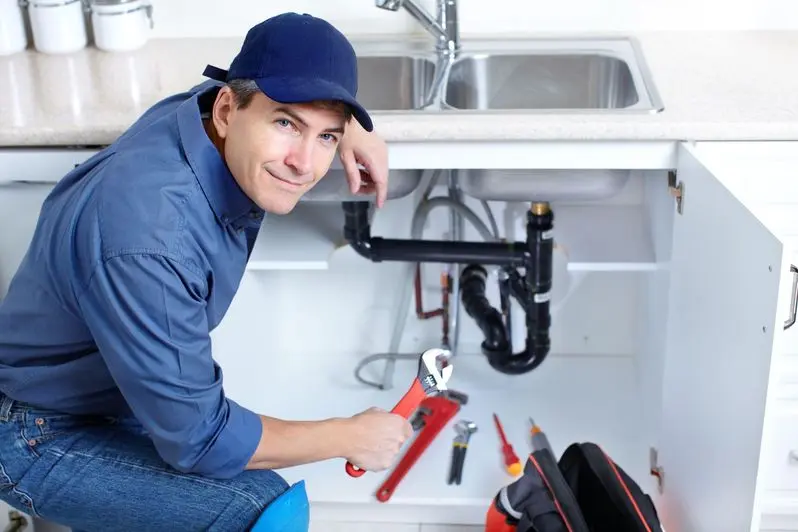 Professional plumber working on a repair