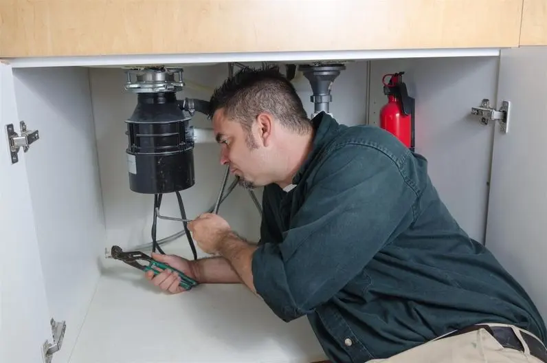man fixing kitchen sink plumbing man fixing kitchen sink plumbing
