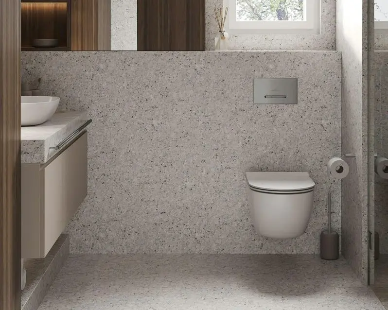 Modern spacious bathroom with bright tiles with toilet and sink.