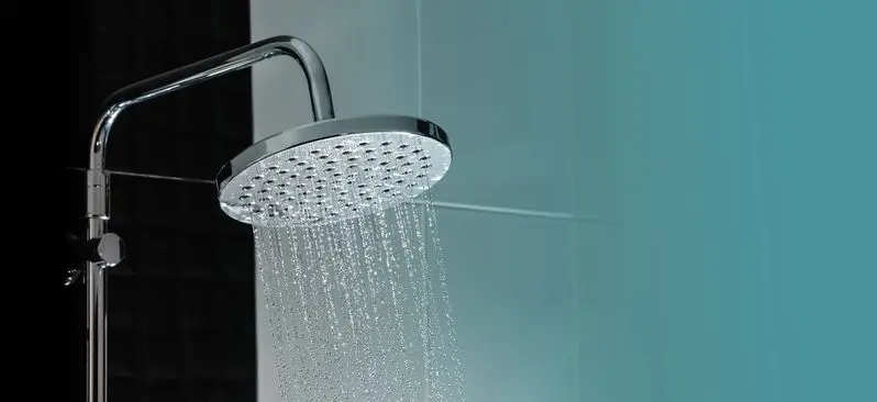 Water flowing from shower in the bathroom interior