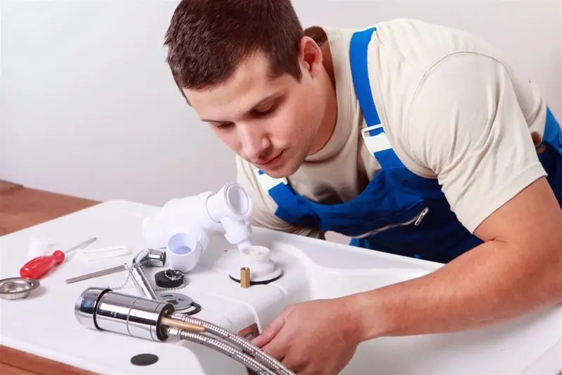 man fixing washing machine drain line man fixing washing machine drain line
