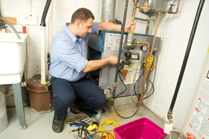 Plumber fixing gas furnace