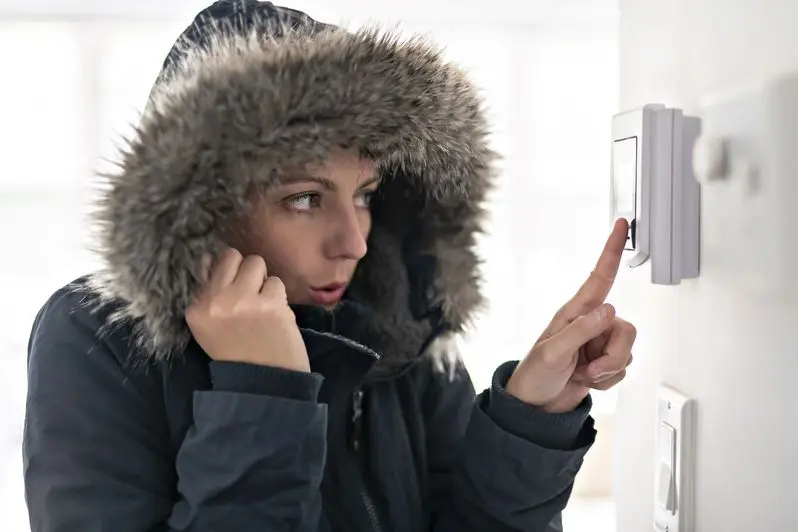 Woman With Warm Clothing Feeling The Cold Inside House