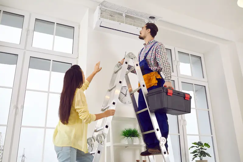 Christianson Air Conditioning and Plumbing professional working on a AC with a client
