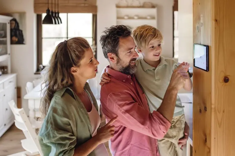 Happy family using their smart thermostat