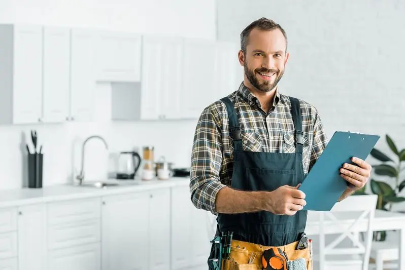 Happy professional plumber with a clipboard